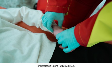 Medical Assistant Checking Pulse During a Medical Emergency. Young Skinny Patient Arm Examination, Before Operation. First Steps During Emergency