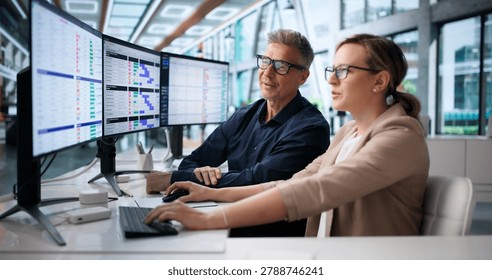 Medical Billing Coder Analyzes Spreadsheet Data On Multiple Computer Screens.
