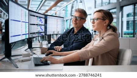 Medical Billing Coder Analyzes Spreadsheet Data On Multiple Computer Screens.
