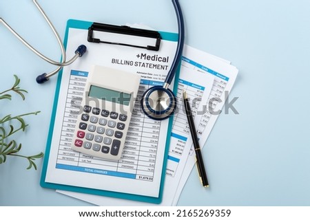 Medical billing statement with calculator, hospital payment, healthcare cost on blue background, top view with copy space