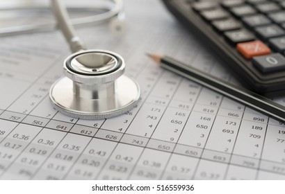medical billing,  stethoscope and calculator on bills for health care costs or medical insurance.