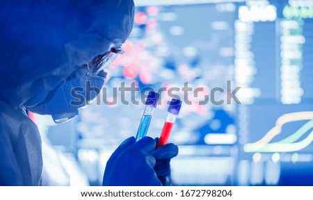 Medical bioengineer working on development vaccines 2019-ncov coronavirus in pharmacy laboratory. Blue colour background.