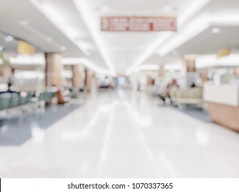 Medical Blur Background Clinic Healthcare Service Center Or Hospital In OPD - Outpatient Department Blurry Interior White Waiting Lobby Room With Patient's , Doctors, Nurse Staff Station Counter Area