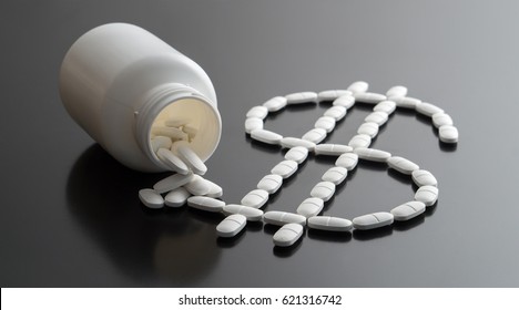 Medical Business Or Prices Concept. Making Money In Pharmaceutical Industry Or High Medical Expenses. Also Drug Dealing, Dealer Or Trade. Dollar Sign Written With Pills Spilled From A Medicine Bottle.