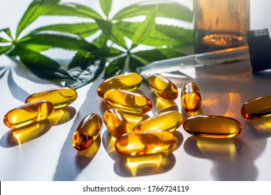 Medical cannabis products: leaf, capsules and CBD oil on white background. Pharmaceutical gelatin softgels with biological plant herbal. Organic dietary supplements concept