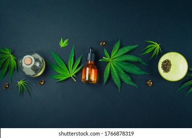 Medical CBD oil on black trendy background with cannabis leaves. The concept of medical tincture of marijuana. Trendy Flat Lay Minimalism Banner