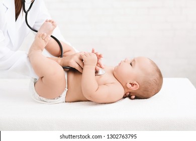 Medical Check Up. Pediatrician Listening To Baby's Lungs And Heart, Close Up