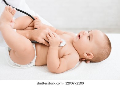 Medical Checkup. Doctor Pediatrician Examining Little Baby With Stethoscope In Clinic