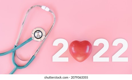 Medical Checkup And Health Insurance On Year 2022 Concept, Stethoscope With Text New Year 2022 On Isolate Pink Background. Doctor Appointment Calendar For Medical Examination Annual 2022. Medical Care