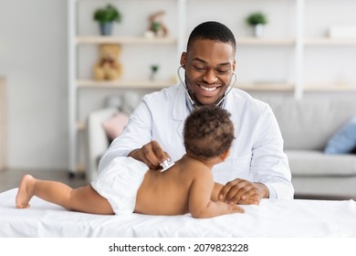 Medical Checkup. Smiling Black Pediatrician Doctor Examining Little Baby With Stethoscope During Appointment In Modern Clinic, Professional Therapist Checking Health Of Infant Child, Free Space