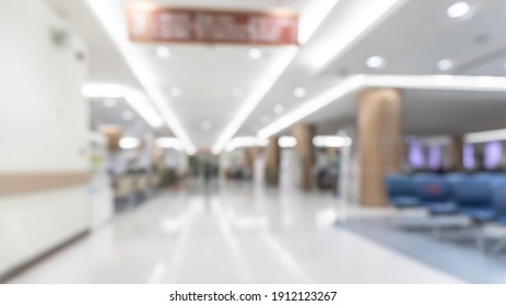 Medical Clinic Blur Background Healthcare Hospital Service Center In OPD - Outpatient Department Blurry Interior White Waiting Lobby Room With Patient's , Doctors, Nurse Staff Station Counter Area