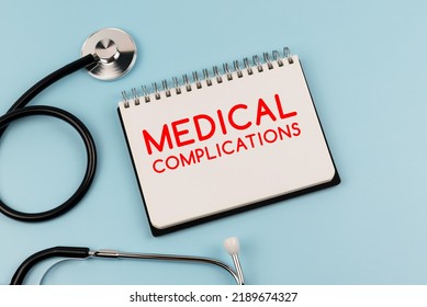 Medical complications text on note pad and stethoscope