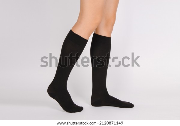 Medical Compression Stockings for varicose veins\
and venouse therapy. Compression Hosiery. Sock for sports isolated\
on white background. Black color socks mock up for advertising,\
branding, design.
