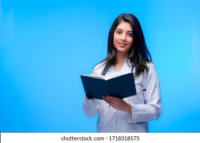 Medical concept of Asian beautiful female doctor in white coat with stethoscope, waist up. Medical student. Woman hospital worker looking at camera and smiling. Covid-19 pandemic.