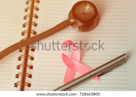 Medical Concept, Breast cancer awareness month. Pink ribbon with Light leak and selective focus.