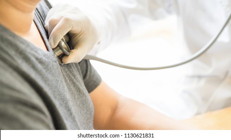 Medical concept.The doctor is checking the patient pulse.Health check.The doctor uses stethoscope to listen to the heart rate of the patient.