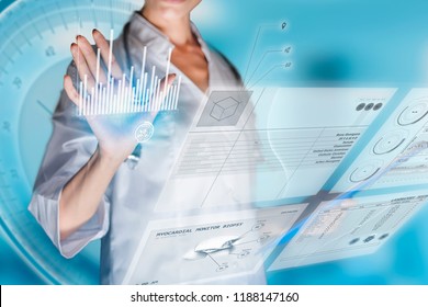 Medical concept of futuristic health care technology and augmented reality. A female doctor hand is touching a virtual innovative control panel to monitor a patient's electronic health records.  - Powered by Shutterstock