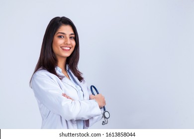 Medical concept of Indian beautiful female doctor in white coat with stethoscope, waist up. Medical student. Woman hospital worker looking at camera and smiling, studio, gray background