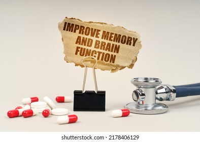 Medical Concept. Near The Stethoscope Are Pills And A Clip With A Cardboard Sign - Improve Memory And Brain Function