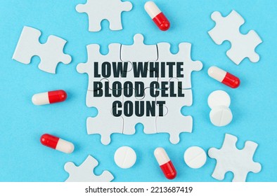 Medical Concept. On A Blue Background, Pills, Capsules And Puzzles With The Inscription - Low White Blood Cell Count