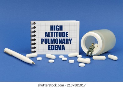 Medical Concept. On A Blue Surface There Is A Jar Of Pills, A Figure Of A Man, A Notepad With The Inscription - High Altitude Pulmonary Edema