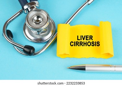 Medical concept. On the blue surface there is a stethoscope, a pen and a yellow sticker with the inscription - Liver cirrhosis