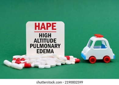 Medical Concept. On A Green Surface, An Ambulance, Pills And A White Sign With The Inscription - High Altitude Pulmonary Edema