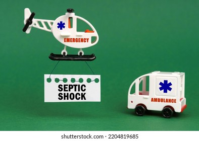 Medical Concept. On A Green Surface, An Ambulance Car And A Helicopter With A Sign - Septic Shock