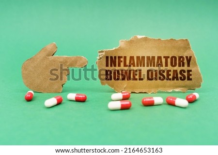 Medical concept. On the green surface of the tablet and a hand pointing to a sign with the inscription - Inflammatory Bowel Disease Stock photo © 