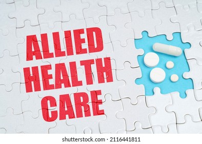 Medical Concept. On The Puzzles There Is An Inscription - Allied Health Care, On A Blue Background Pills.