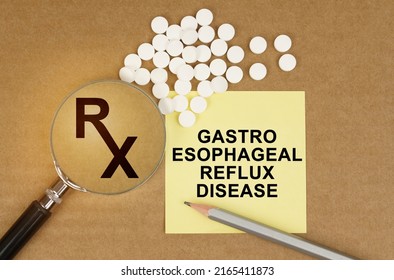 Medical Concept. On The Table Are Pills, A Magnifying Glass, Pencils And A Sticker With The Inscription - Gastro Esophageal Reflux Disease