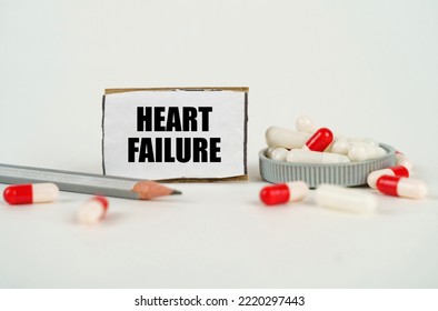 Medical Concept. On A White Background, Medical Capsules, A Pencil And A Cardboard Plate With The Inscription - Heart Failure