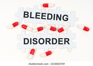 Medical Concept. On A White Surface, Tablets And Puzzles With The Inscription - Bleeding Disorder