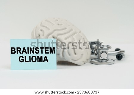Medical concept. On a white surface next to the brain there is a stethoscope and stickers with the inscription - Brainstem glioma