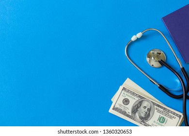 Medical Concept. Payment For The Services Of A Doctor. Costly Treatment. Stethoscope And Dollars On Blue Background