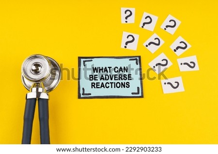 Medical concept. Question. On a yellow background a stethoscope, question marks and a blue sticker with the inscription - What can be adverse reactions