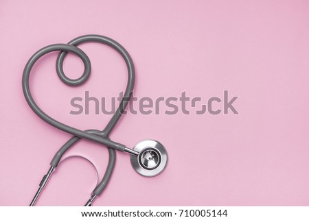 Medical concept. The stethoscope with heart shape on pink background.