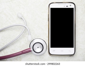 Medical Concept Stethoscope And Smart Phone On Table Background