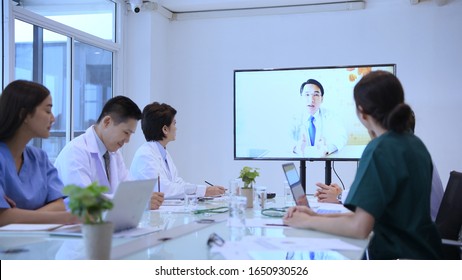 Medical Concept. The Medical Team Is Communicating With The Video Call. Within The Meeting Room Of The Hospital.