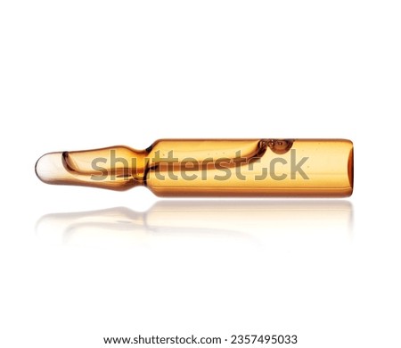 Medical or cosmetic ampoule lies on a white background with reflection