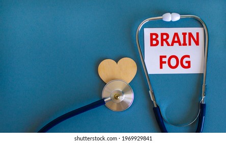 Medical, Covid-19 And Brain Fog Symbol. White Card With Words 'brain Fog' And Stethoscope On Blue Background. Wooden Heart. Medical, Covid-19 Brain Fog Concept. Copy Space.