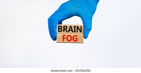 Medical And COVID-19 Pandemic Coronavirus Brain Fog Symbol. Doctor Holds Wooden Blocks With Words 'brain Fog'. Beautiful White Background. Copy Space. Medical And Covid-19 Brain Fog Concept.