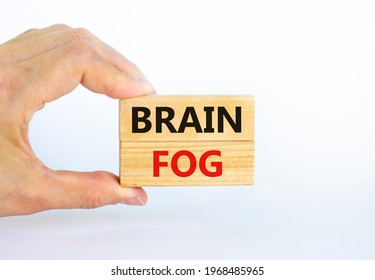 Medical And COVID-19 Pandemic Coronavirus Brain Fog Symbol. Doctor Holds Wooden Blocks With Words 'brain Fog'. Beautiful White Background. Copy Space. Medical And Covid-19 Brain Fog Concept.