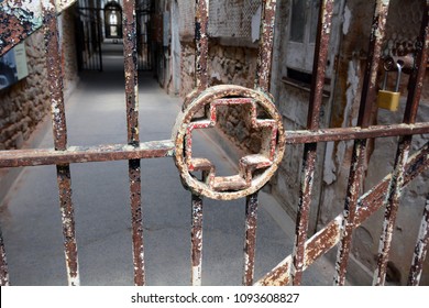 Medical Cross Symbol in the Bars of an Abandoned Prison Hospital Cell Block