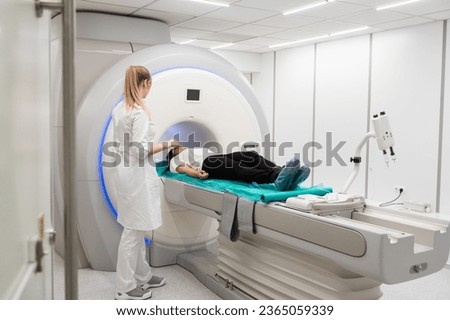 Medical CT or MRI Scan with a patient in the modern hospital laboratory. Interior of radiography department. Technologically advanced equipment in white room. Magnetic resonance diagnostics machine