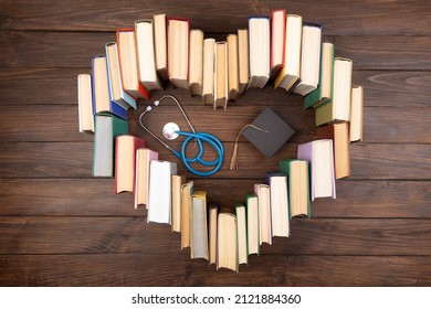 Medical Degree Education Concept - Stack Of Books In Heart Shape And Stethoscope In The Library. Love To Study Medicine