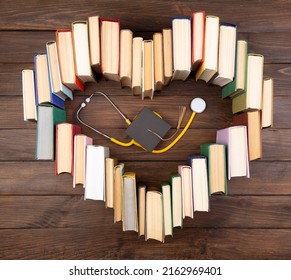 Medical Degree Education Concept - Stack Of Books In Heart Shape And Stethoscope In The Library. Love To Study Medicine