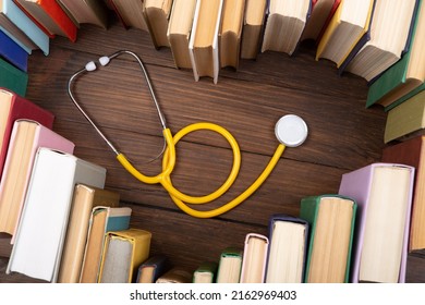 Medical Degree Education Concept - Stack Of Books In Heart Shape And Stethoscope In The Library. Love To Study Medicine