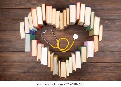 Medical Degree Education Concept - Stack Of Books In Heart Shape And Stethoscope In The Library. Love To Study Medicine