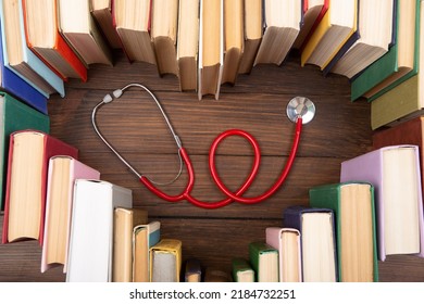 Medical Degree Education Concept - Stack Of Books In Heart Shape And Stethoscope In The Library. Love To Study Medicine